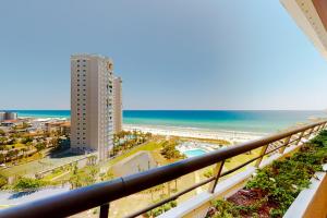 a view of the beach and the ocean from a balcony at Edgewater Beach Resort 1301 in Destin
