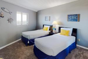 a small room with two beds and a window at Edgewater Beach Resort 1301 in Destin