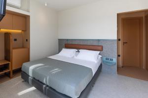 a bedroom with a large bed with white pillows at Evripides Hotel in Athens