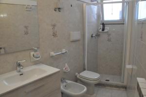 a bathroom with a toilet and a shower and a sink at Appartamento di villa gesualda in Serrara Fontana +22 photos