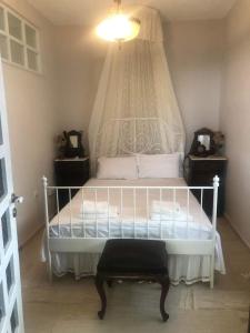 a bedroom with a white bed with a canopy at CASA LOUKAS in Nerotriviá