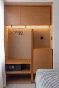 a small room with a bed and a cabinet and a bed at Evripides Hotel in Athens
