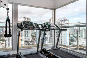 a gym with a view of a city at Comfy Apartment City Center - PH Quartier Atlapa in Panama City