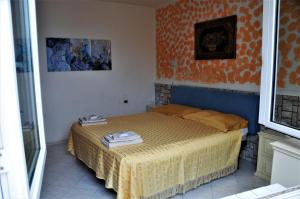 a small bedroom with a bed in a room at Appartamento di villa gesualda in Serrara Fontana