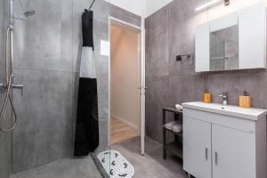 a bathroom with a shower and a sink at Luna solari Apartment in Mantoúkion
