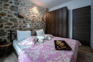 ein Schlafzimmer mit einem rosa Bett und einem Tablett darauf in der Unterkunft Lilaia's View in Lílaia
