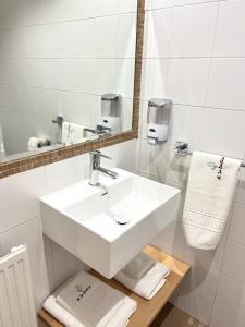 a white bathroom with a sink and a mirror at Hostal LA POETISA - Auto Check-in in Culleredo