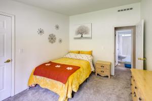 a bedroom with a bed with a yellow blanket at Peaceful Hideaway about 16 Mi to Downtown Missoula! in Wye