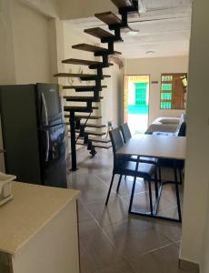 a kitchen with a table and chairs and a piano at APARTAMENTO LOLACELE in Jardin