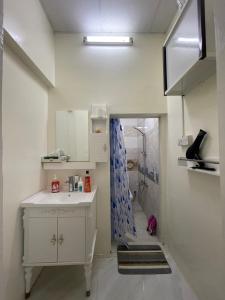 a bathroom with a sink and a shower at Private 2Bedroom Villa with T&B and Kitchenette near Abu Dhabi International Airport in Abu Dhabi