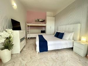 a bedroom with a bed and a bunk bed and a tv at Dolce Basilico in Agropoli