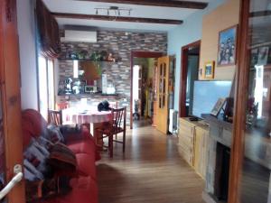 a living room with a red couch and a table at Vicky apart in Calafell