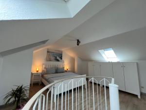 a bedroom with a white bed in a attic at Wunderschöne Wohnung mit Balkon in Plauen in Plauen