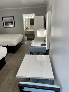 a room with two beds and a table and a mirror at Quality Inn & Suites Georgetown in Georgetown