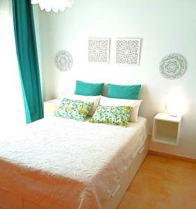 a bedroom with a bed with two pillows on it at Piso Sierra Calderona a 15 minutos del mar Estivella in Estivella