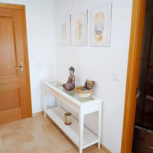 a white table with some figurines on it in a room at Piso Sierra Calderona a 15 minutos del mar Estivella in Estivella