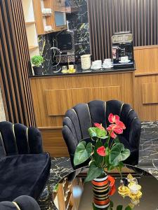 a room with two chairs and a table with a vase with flowers at historia hotel in Istanbul