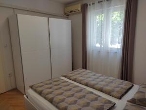 Postel nebo postele na pokoji v ubytování Grey House Zadar