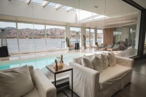 a living room with a couch and a swimming pool at Veneto Village in Villa Parque Siquiman