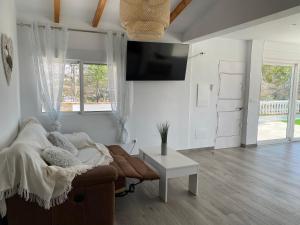 a living room with a couch and a flat screen tv at Entre montañas in Árchez