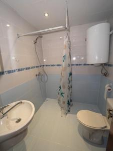 a bathroom with a sink and a toilet and a shower at Buongiorno! Premium in Sveti Vlas