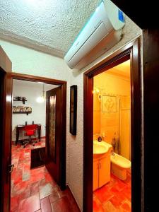 a room with a bathroom with a sink and a toilet at Residence La Villa in Montescudaio