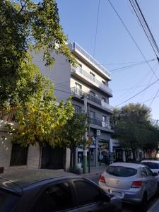 a white car parked in front of a building at DELFINA suites 3A in La Rioja