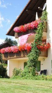 a building with flowers on the side of it at Bauer Haug in Dietmannsried