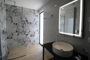a bathroom with a sink and a mirror at Julia Hotel in Sarandë