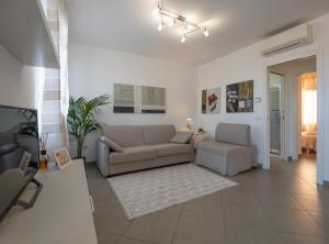 a living room with a couch and two chairs at Appartamento Lavanda "A Casa Felice" in Pietra Ligure