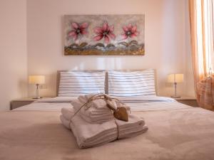 a bedroom with a bed with a towel on it at Appartamento Lavanda "A Casa Felice" in Pietra Ligure