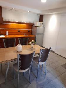 a kitchen with a wooden table with chairs and a kitchen at PH Solís in Mar del Plata