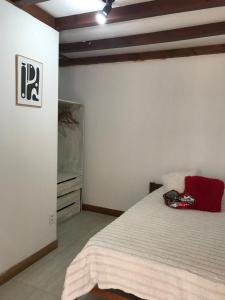 a bedroom with a bed and a dresser in a room at PH Solís in Mar del Plata