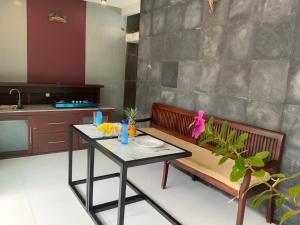 a kitchen with a table and a bench and a table at Bali Elephants Boutique Villa in Jimbaran