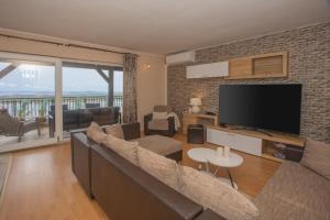 a living room with a couch and a flat screen tv at Apartment Mozart in Šibenik