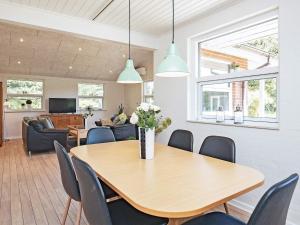 a dining room with a table and chairs at 6 person holiday home in Bl vand in Ho