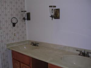 a bathroom with a sink and two lights on the wall at Lovely Room in Huntington