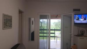 a living room with a tv and a sliding glass door at In the nature by Marko in Benkovac