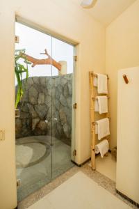 a bathroom with a shower and a glass door at Casa Don Luis Lujosa casa frente a la playa 