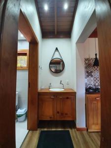 a bathroom with a sink and a mirror at Rancho 4 Corações in Urubici