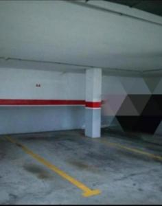 an empty parking garage with a red and white wall at Toledo Enamora Dos - PARKING INCLUIDO in Toledo