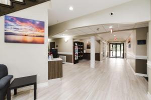 a lobby of a hospital with a painting on the wall at SureStay Studio by Best Western Conroe Downtown in Conroe