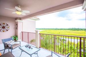 balcón con mesa, sillas y vistas en LakeView Penthouse 3 Bedroom In Vista Cay condo en Orlando
