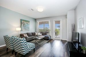 a living room with a couch and a tv at Lake View 3 Bedroom In Vista Cay Resort condo in Orlando