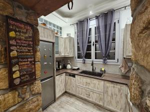 a kitchen with a refrigerator and a sink at Athens Timeless Escape in Athens