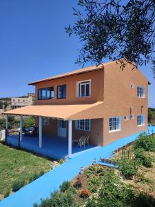 a house with a pool in front of it at Dar Aya Dmina in Demina
