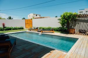 una piscina en un patio trasero con terraza de madera en Vila Tuga, en Prea