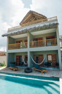 a villa with a balcony and a swimming pool at Vila Tuga in Prea