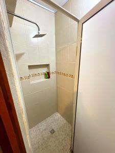 a shower with a glass door in a bathroom at Hospédate en Paseo Santa Lucía - LOFT in Monterrey
