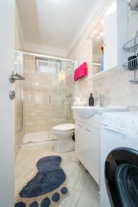 a bathroom with a shower and a toilet and a sink at Apartments by the sea Sali, Dugi otok - 19880 in Sali